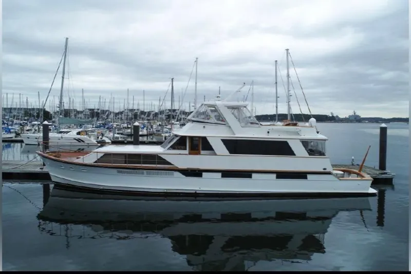 Slide: The Image of 1974 Pacemaker Cockpit Motoryacht docked in a marina under cloudy skies. - 54