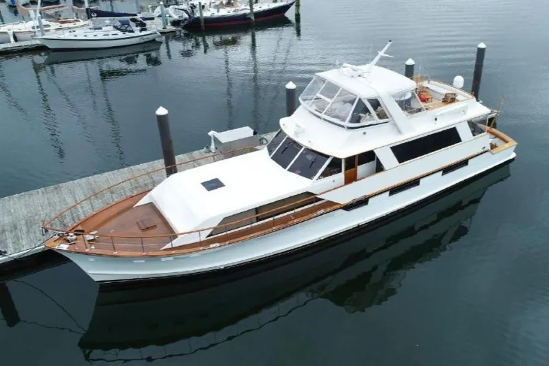 Slide: The Image of 1974 Pacemaker Cockpit Motoryacht docked at marina, featuring classic design and spacious deck. - 55