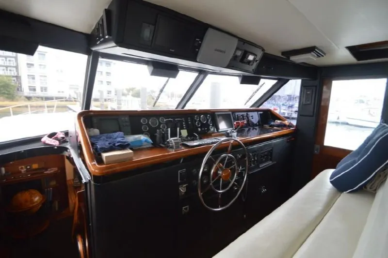 Slide: The Image of 1974 Pacemaker Cockpit Motoryacht interior with steering wheel and control panel. - 61
