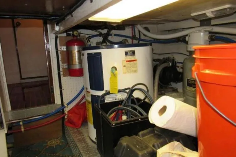 Slide: The Image of Engine room of a 1974 Pacemaker Cockpit Motoryacht with equipment and storage items. - 67