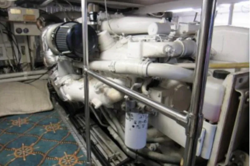 Slide: The Image of Engine room of a 1974 Pacemaker Cockpit Motoryacht, featuring complex machinery and piping. - 69