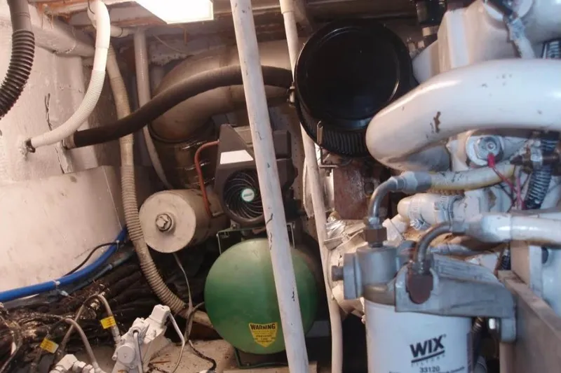 Slide: The Image of Engine room of a 1974 Pacemaker Cockpit Motoryacht with visible machinery and components. - 70