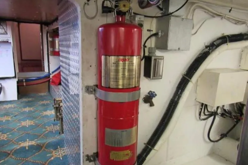 Slide: The Image of 1974 Pacemaker Cockpit Motoryacht interior with red fire extinguisher and nautical-themed carpet. - 72
