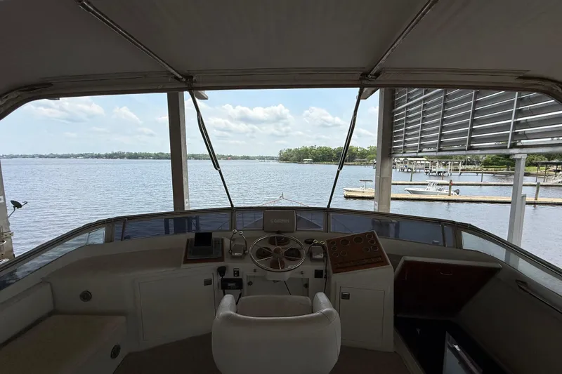 Slide: The Image of 1974 Pacemaker Cockpit Motoryacht helm with scenic waterfront view. - 75