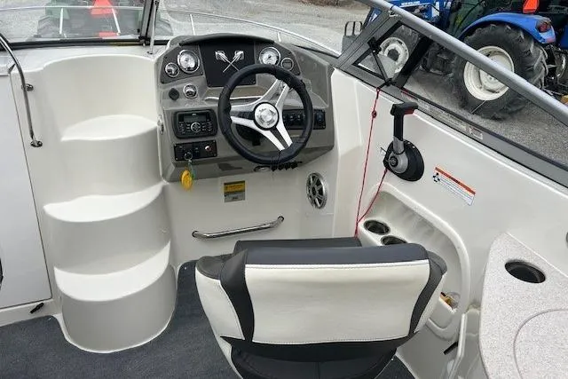 Slide: The Image of 2017 Stingray 250 CR boat cockpit with steering wheel and control panel. - 10