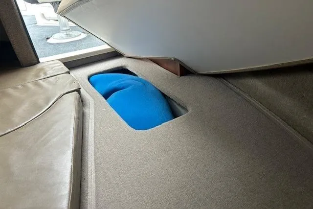 Slide: The Image of 2017 Stingray 250 CR boat interior storage compartment with blue item inside. - 11