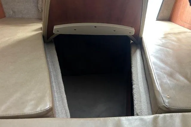 Slide: The Image of Interior cabin view of a 2017 Stingray 250 CR boat, featuring cushioned seating. - 12