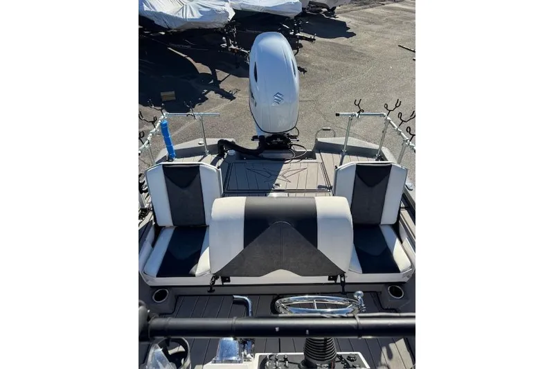 Slide: The Image of 2023 Vexus AVX1980CC boat interior with seating and motor, ideal for fishing trips. - 10