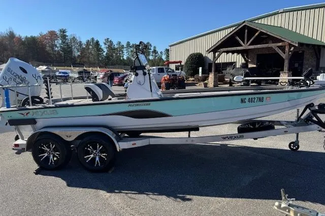 Slide: The Image of 2023 Vexus AVX1980CC boat on trailer, parked outdoors near a building. - 4