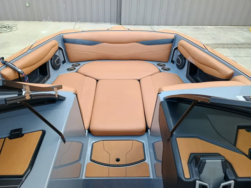 Slide: The Image of 2024 Axis A245 boat interior with tan leather seating and cup holders. - 4