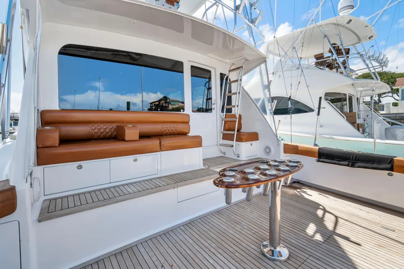 Slide: The Image of Luxurious 2005 Viking 61 Convertible yacht with elegant seating and fishing rod holders. - 10