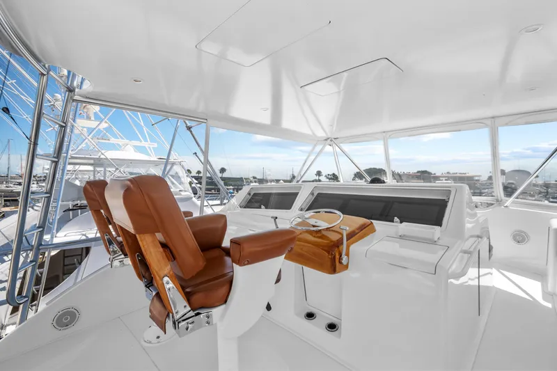 Slide: The Image of 2005 Viking 61 Convertible yacht helm with leather seats and panoramic view. - 13