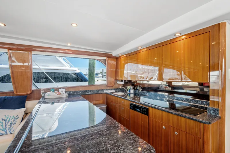 Slide: The Image of Luxurious kitchen interior of 2005 Viking 61 Convertible yacht with sleek wood cabinetry. - 17