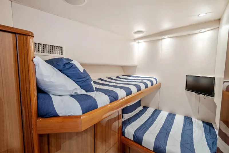 Slide: The Image of 2005 Viking 61 Convertible yacht cabin with bunk beds and wall-mounted TV. - 22