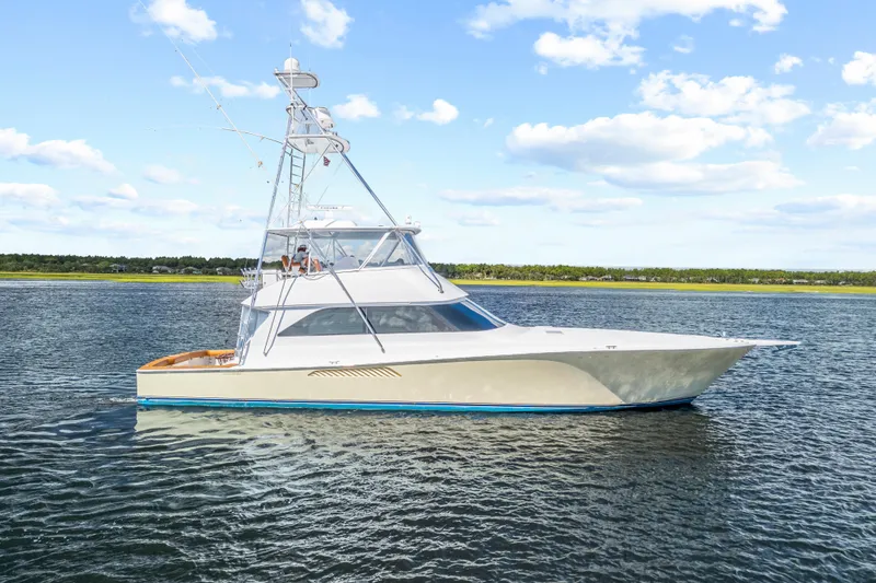 Slide: The Image of 2005 Viking 61 Convertible yacht cruising on a calm, scenic waterway. - 6