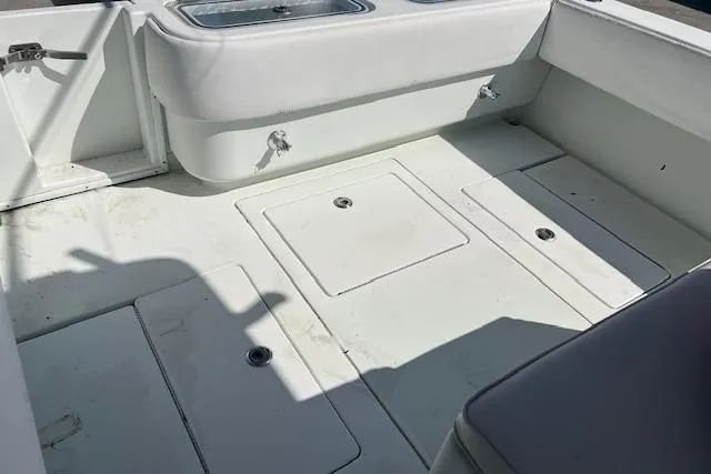 Slide: The Image of 2008 Contender 31 Fisharound boat deck with storage compartments and seating. - 2