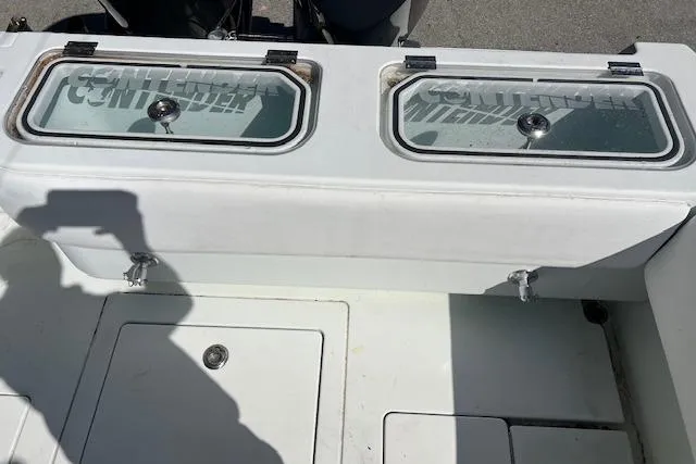Slide: The Image of 2008 Contender 31 Fisharound boat deck with storage compartments and Contender branding. - 4