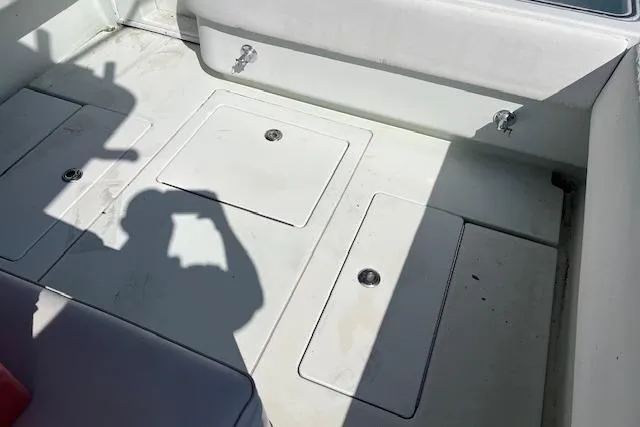 Slide: The Image of 2008 Contender 31 Fisharound deck with storage compartments and shadow. - 5