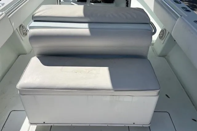 Slide: The Image of 2008 Contender 31 Fisharound boat seating area with cushioned bench. - 6