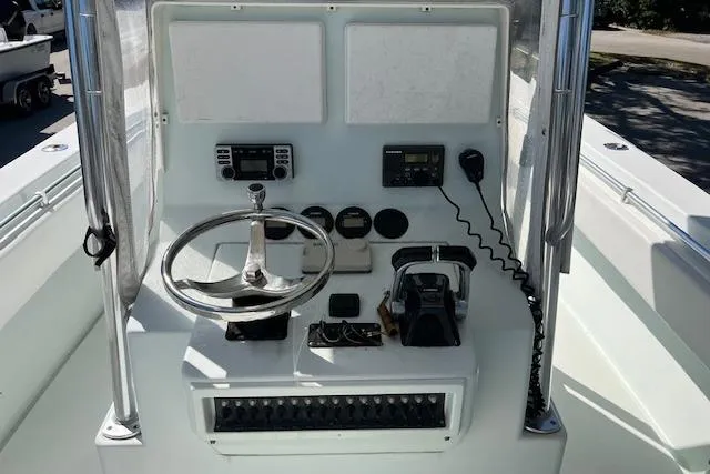 Slide: The Image of 2008 Contender 31 Fisharound boat console with steering wheel and navigation controls. - 9