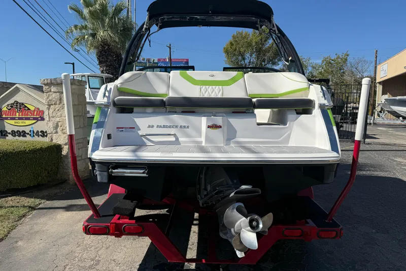 Slide: The Image of 2018 Regal 22 FasDeck boat on trailer, rear view with propeller, outdoor setting. - 4