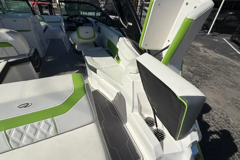Slide: The Image of 2018 Regal 22 FasDeck boat interior with white and green seating, modern design. - 6