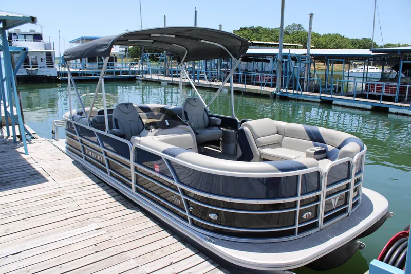 Slide: The Image of 2022 Trifecta RFLE pontoon boat docked at a marina, featuring spacious seating and canopy. - 3