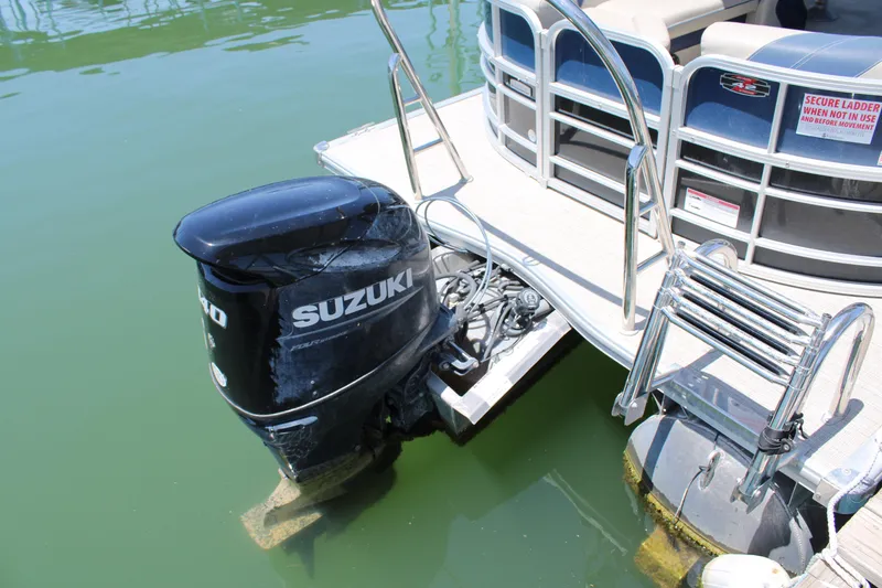 Slide: The Image of 2022 Trifecta RFLE boat with Suzuki outboard motor on calm water. - 8