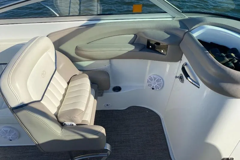 Slide: The Image of Interior of a 2002 Cobalt 282 boat featuring a beige captain's chair and dashboard. - 10