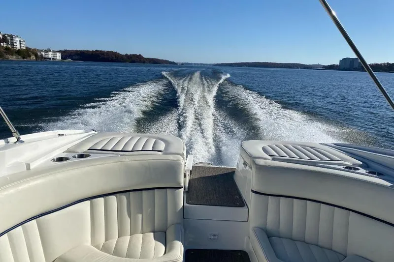 Slide: The Image of 2002 Cobalt 282 boat cruising on a lake, leaving a wake behind. - 17