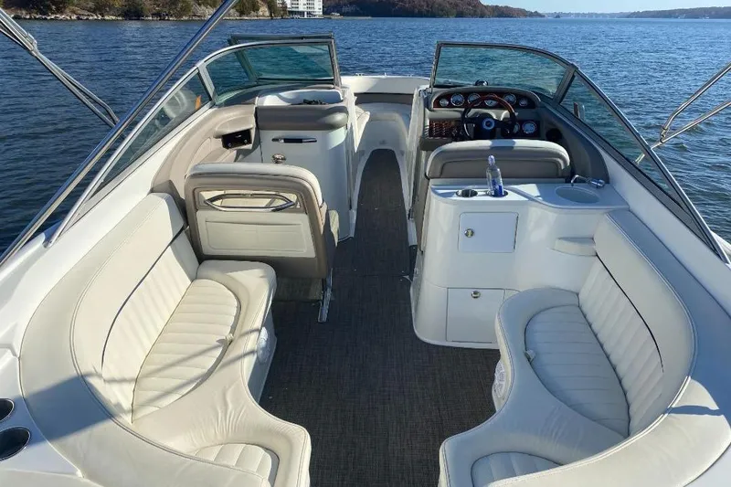 Slide: The Image of 2002 Cobalt 282 boat interior with white seating, on a calm lake. - 5