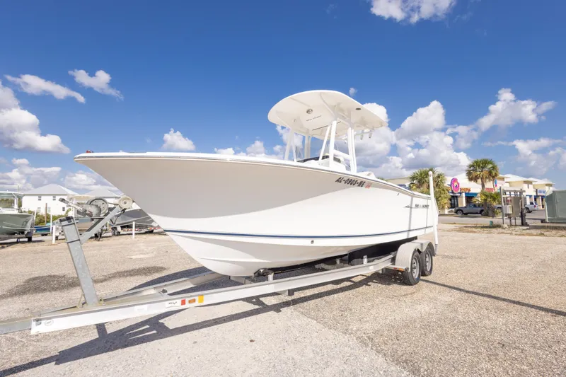 Slide: The Image of 2012 Sea Hunt Ultra 225 boat on trailer under clear blue sky. - 10