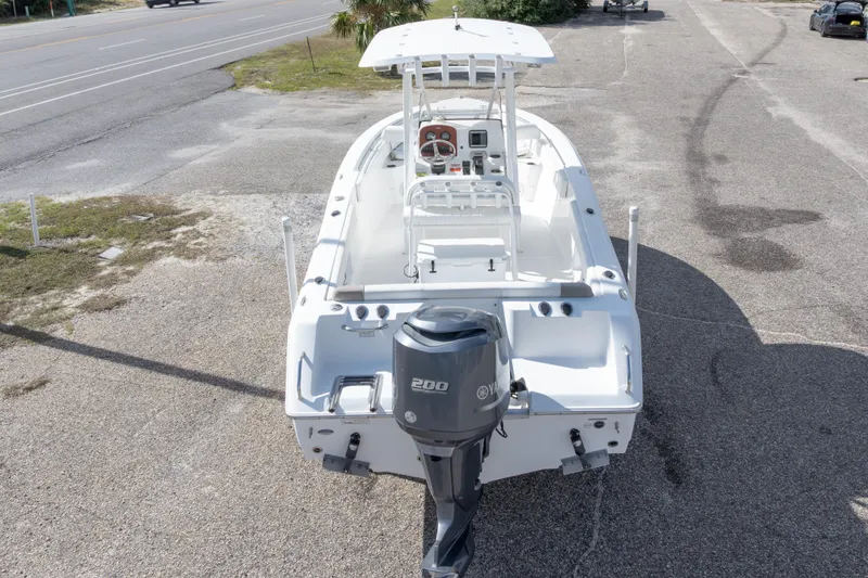 Slide: The Image of 2012 Sea Hunt Ultra 225 boat with Yamaha 200 engine, parked on pavement. - 12
