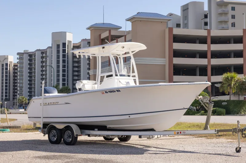 Slide: The Image of 2012 Sea Hunt Ultra 225 boat on trailer, urban background with tall buildings. - 2