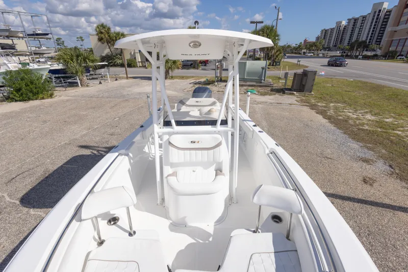 Slide: The Image of 2012 Sea Hunt Ultra 225 boat on a sunny day, parked near a road. - 20
