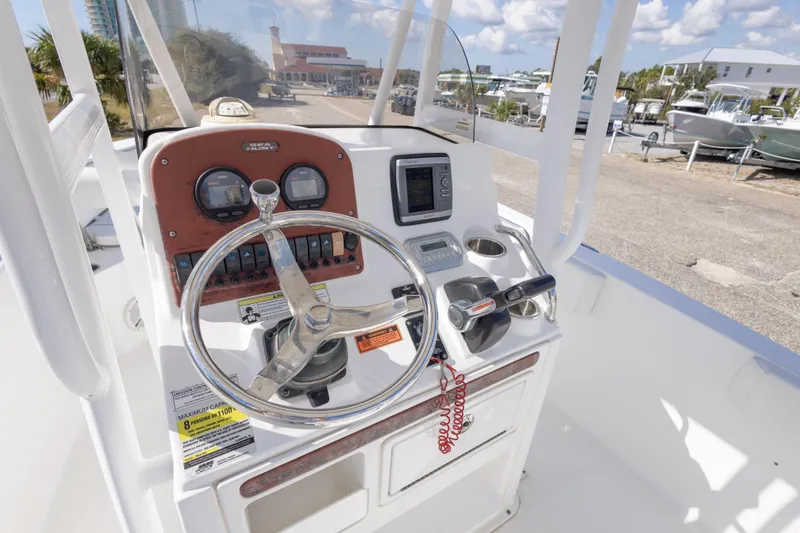 Slide: The Image of 2012 Sea Hunt Ultra 225 boat console with steering wheel and controls. - 21
