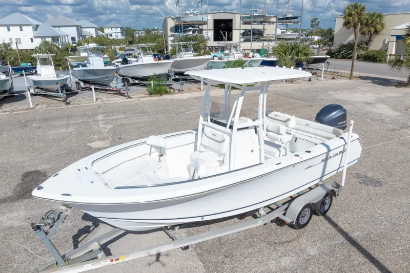 Slide: The Image of 2012 Sea Hunt Ultra 225 boat on trailer in marina setting. - 3