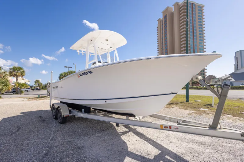 Slide: The Image of 2012 Sea Hunt Ultra 225 boat on trailer, urban background, clear sky. - 4