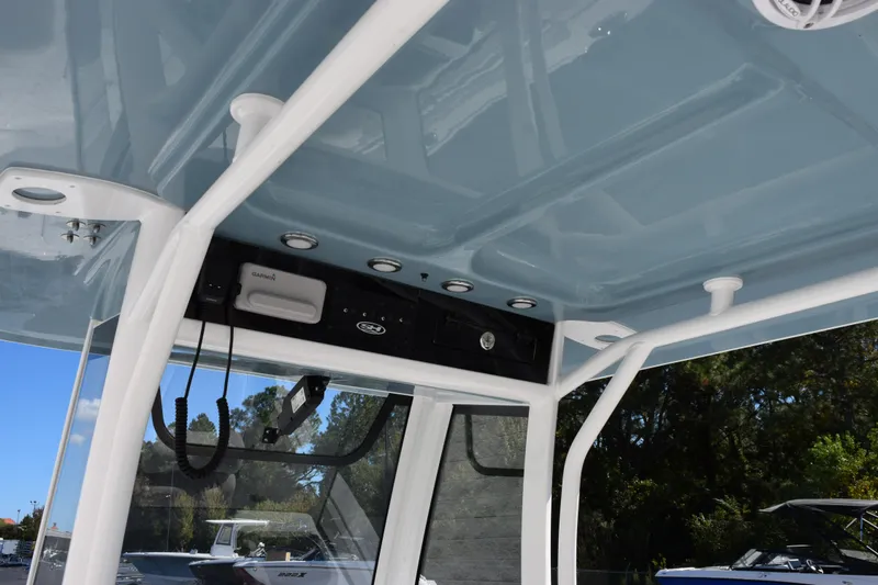 Slide: The Image of 2026 Sea Hunt Ultra 265 SE boat interior with electronics and blue ceiling. - 10