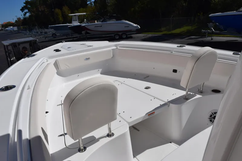 Slide: The Image of 2026 Sea Hunt Ultra 265 SE boat interior with white seating and spacious deck. - 11