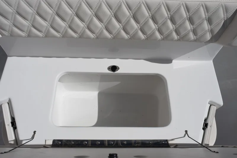 Slide: The Image of 2026 Sea Hunt Ultra 265 SE boat storage compartment with quilted seat cushion. - 15