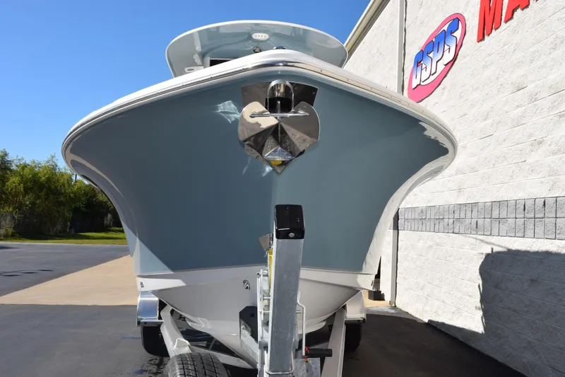 Slide: The Image of 2026 Sea Hunt Ultra 265 SE boat on trailer, parked near a marine dealership. - 3