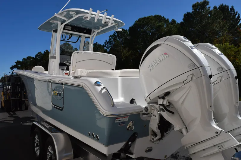 Slide: The Image of 2026 Sea Hunt Ultra 265 SE boat with dual Yamaha engines on a trailer. - 6