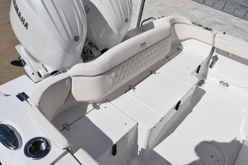 Slide: The Image of 2026 Sea Hunt Ultra 265 SE boat interior with Yamaha engines, featuring white seating and storage. - 7