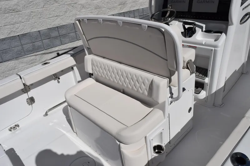 Slide: The Image of 2026 Sea Hunt Ultra 265 SE boat interior with cushioned seating and modern controls. - 8