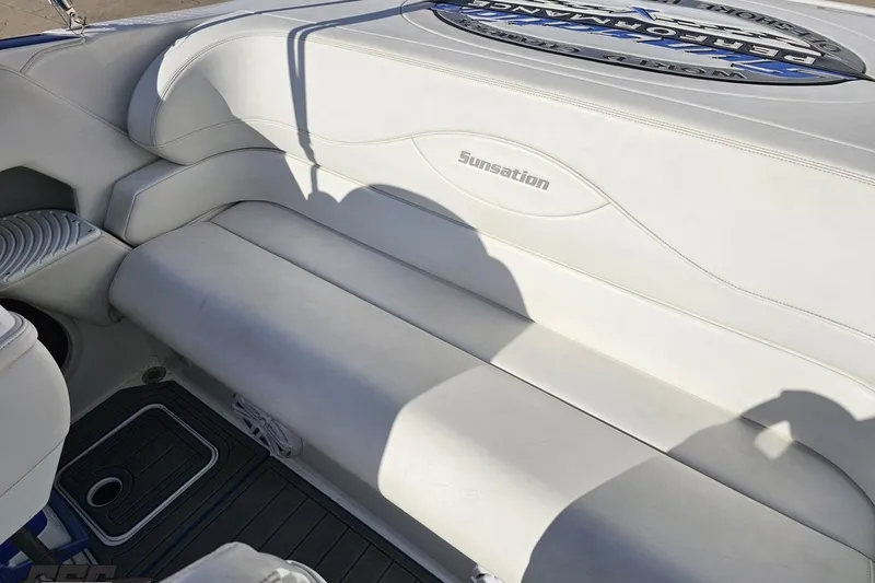 Slide: The Image of 2010 Sunsation 288 MID-CABIN boat interior with white seating and logo. - 104