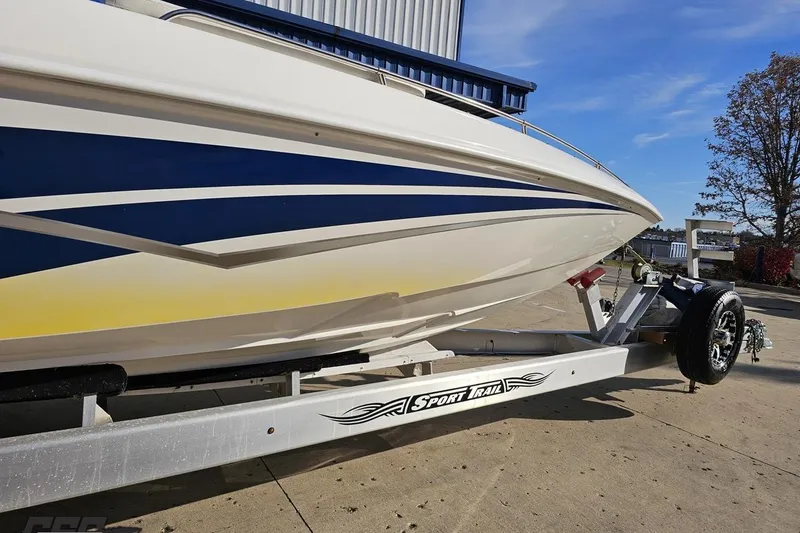 Slide: The Image of 2010 Sunsation 288 MID-CABIN boat on Sport Trail trailer, parked outdoors. - 14