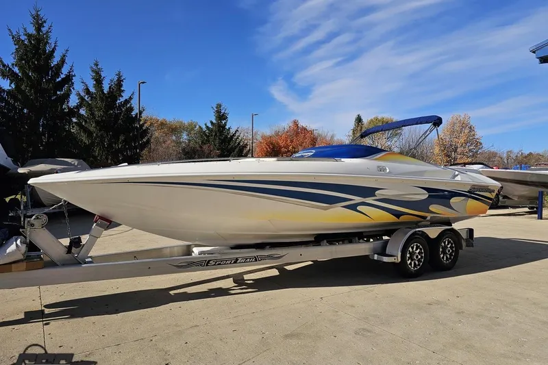 Slide: The Image of 2010 Sunsation 288 MID-CABIN boat on trailer, vibrant graphics, clear sky background. - 20