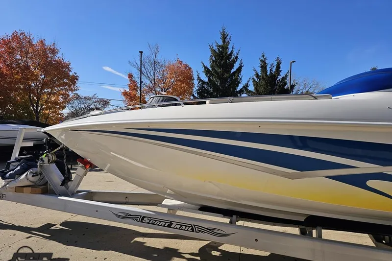 Slide: The Image of 2010 Sunsation 288 MID-CABIN boat on trailer, vibrant graphics, autumn trees in background. - 22