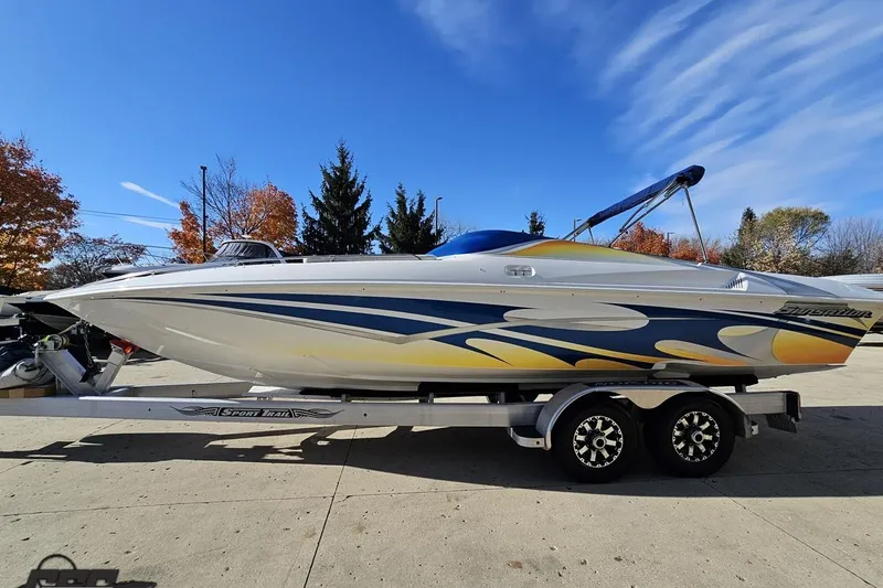 Slide: The Image of 2010 Sunsation 288 MID-CABIN boat on trailer, vibrant design, clear sky background. - 23